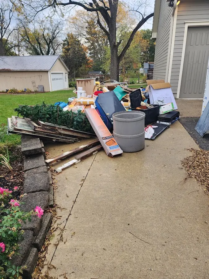 Dumpster being loaded with debris for 12 Yard Dumpster Rental in Orangeburg